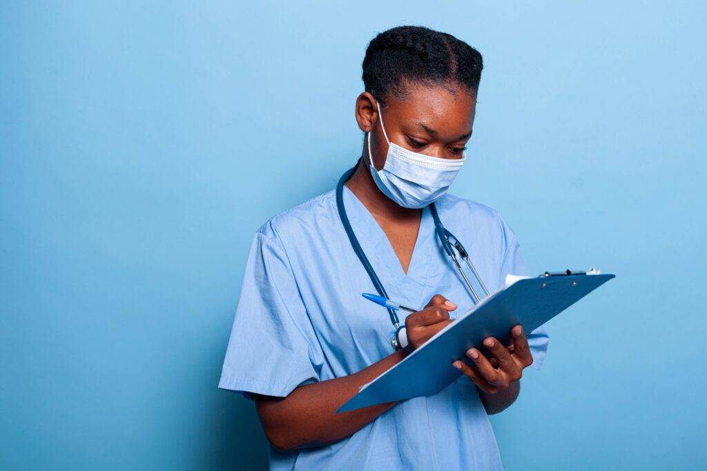 African american therapist nurse putting on a nose mask.