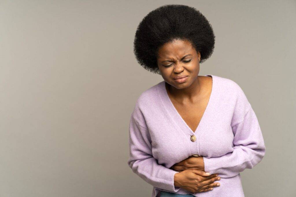 A woman experiencing stomach upset due to stage fright