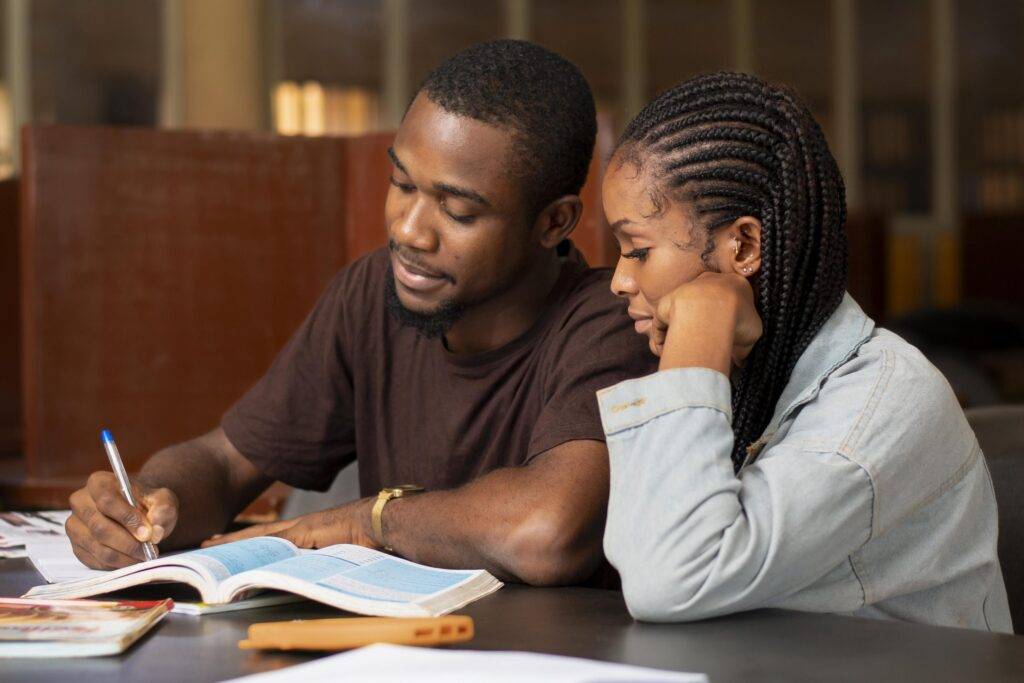 close up of a man teaching his girlfriend her assignment