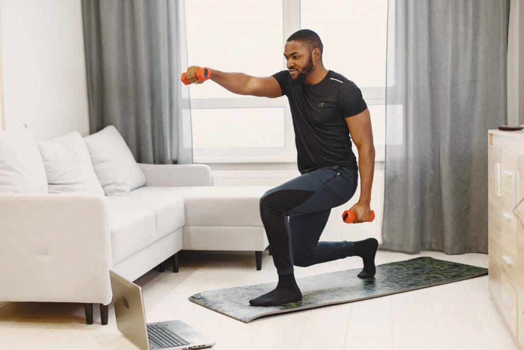 Handsome Afro American sportsman working out at home