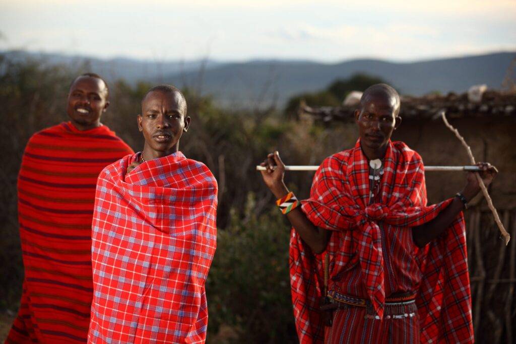 Mental health problems in Africa: A shallow focus shot of three African males with blankets wrapped around them