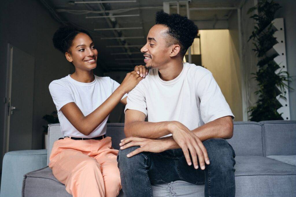 Young attractive cheerful casual African American couple happily